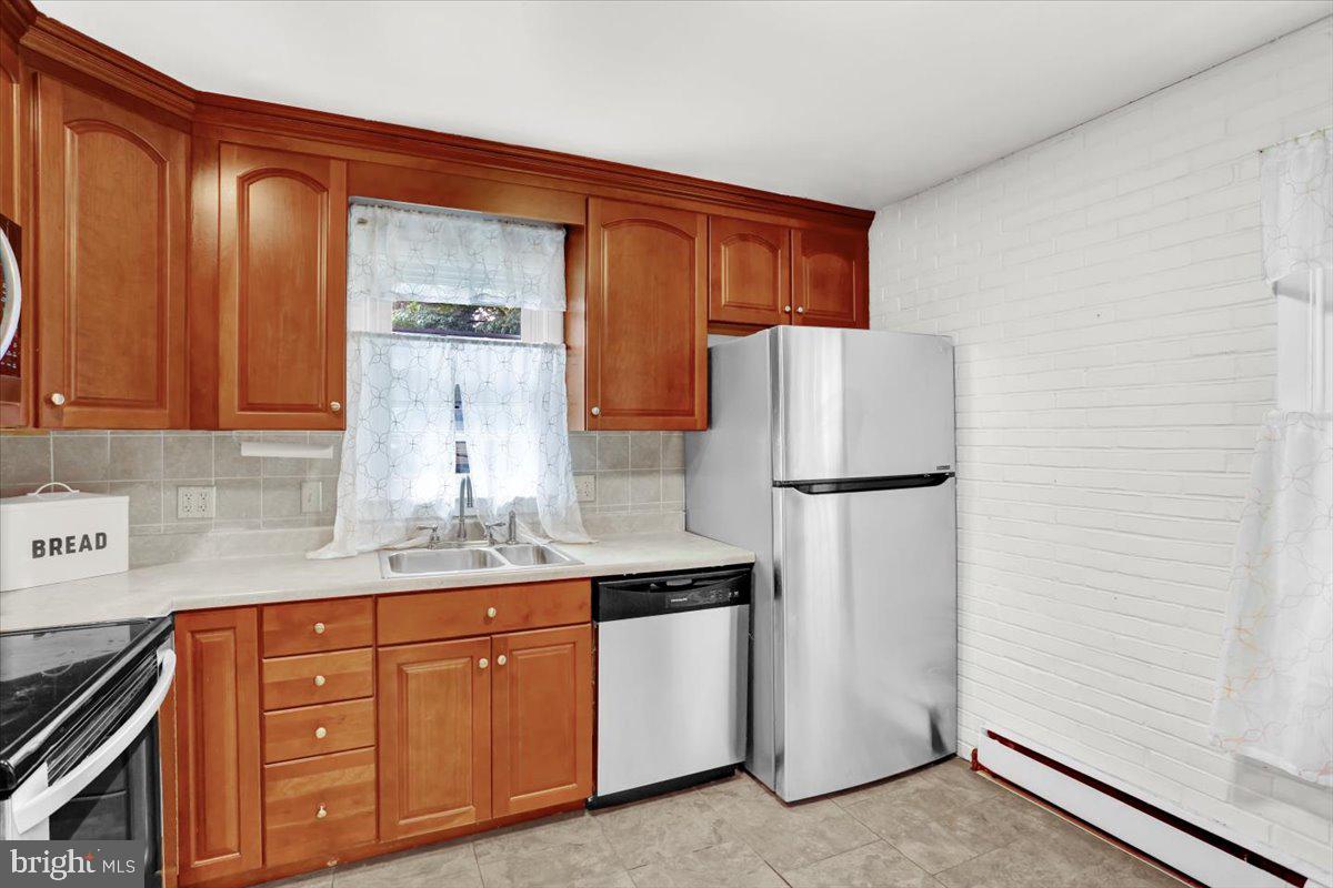 416 Green Lane Reading, PA 19601 - Photo 13 of 42 a kitchen with stainless steel appliances granite countertop a refrigerator a sink and cabinets