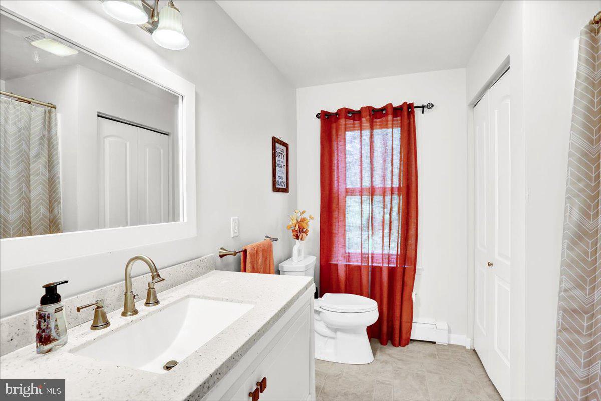 416 Green Lane Reading, PA 19601 - Photo 26 of 42 a bathroom with a sink a toilet and shower curtain