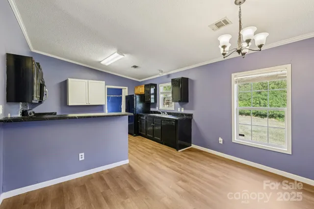 a kitchen with stainless steel appliances kitchen island granite countertop a stove a sink and a microwave