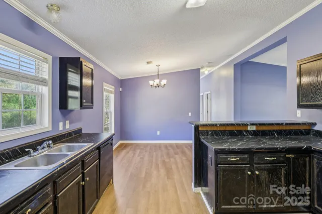 a kitchen with a stove and a wooden cabinets