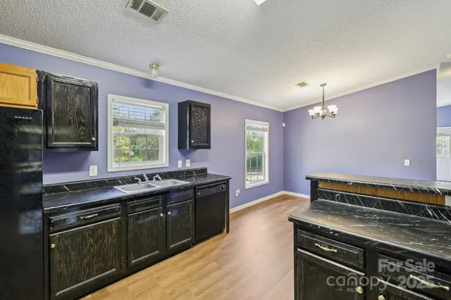 a kitchen with stainless steel appliances granite countertop a stove microwave and refrigerator