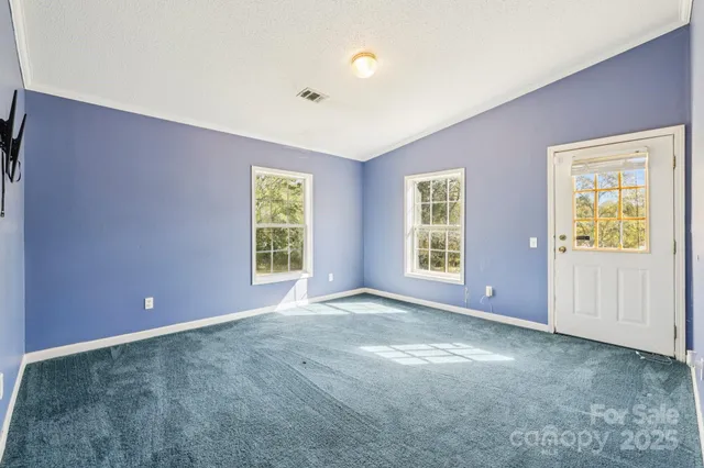 an empty room with windows and closet