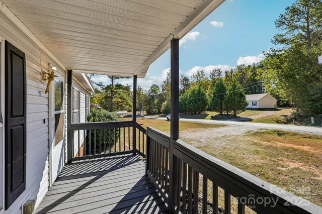 a view of a balcony with wooden floor
