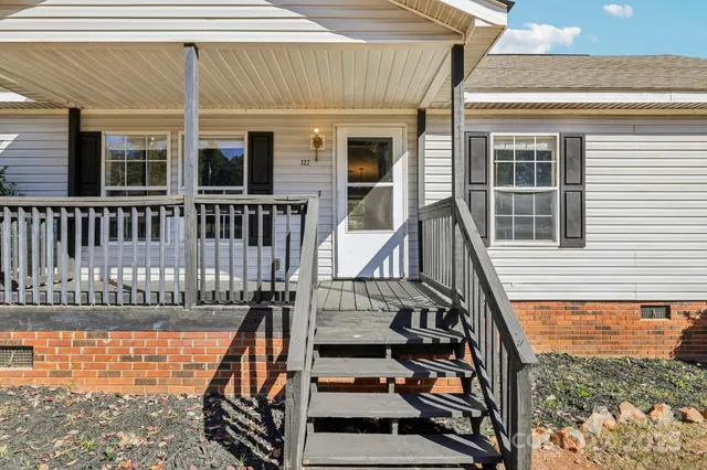 a view of a house with a wooden deck