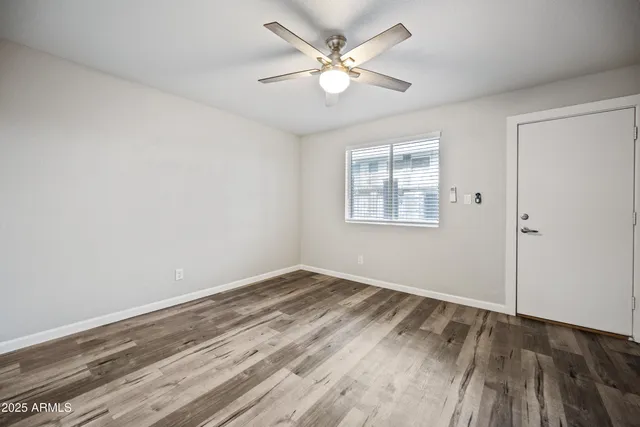 wooden floor in an empty room with a window