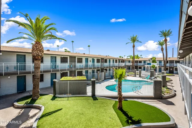 a view of a swimming pool with a patio and a garden