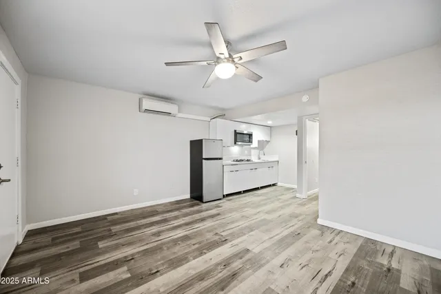 a view of a kitchen with a microwave and cabinets