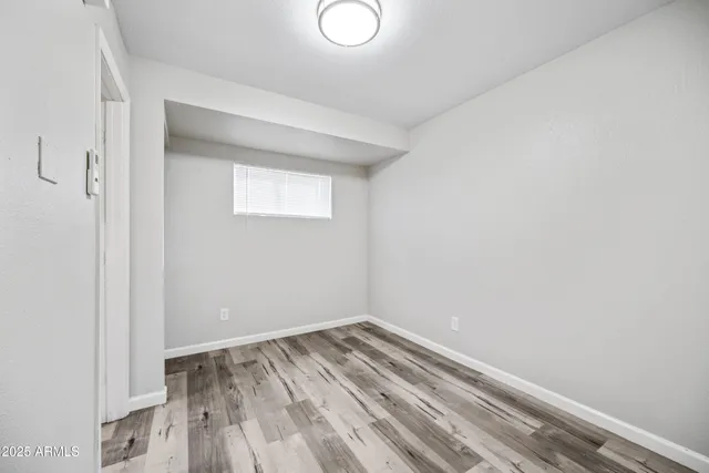 a view of a room with wooden floor and white walls