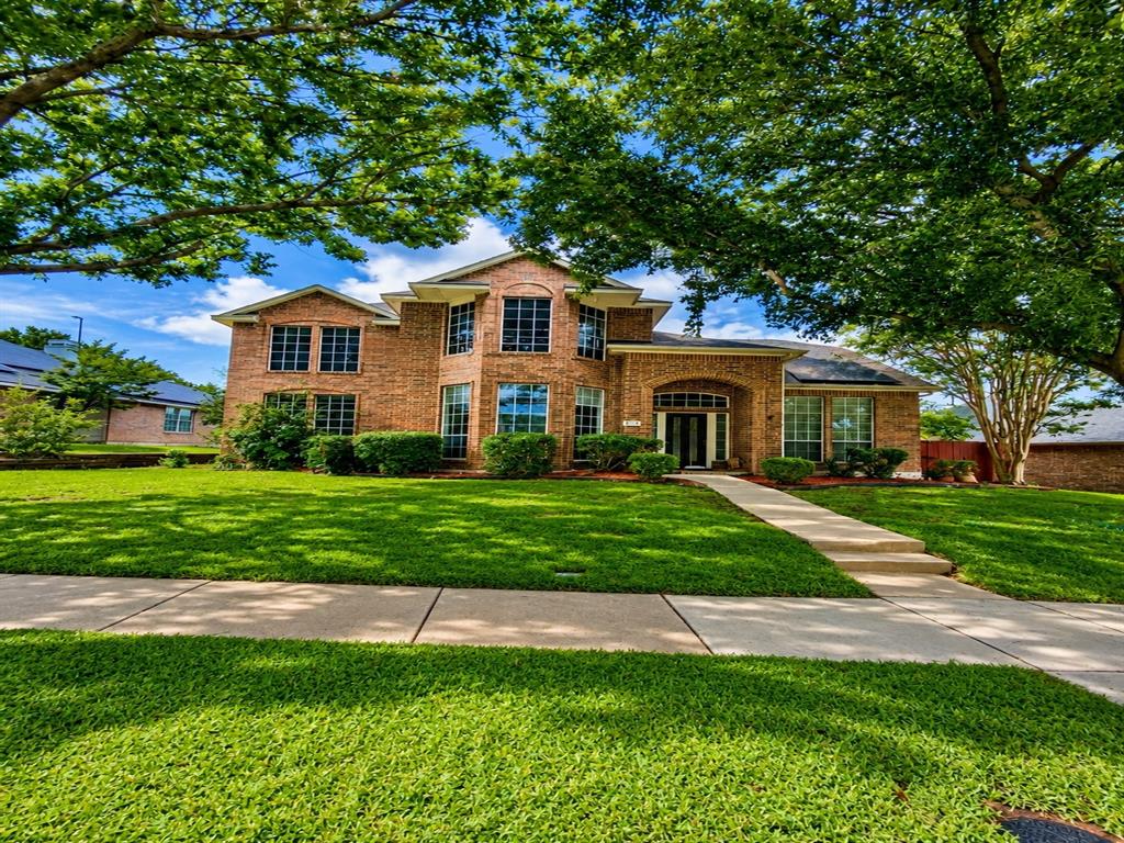 2418 Sherbrooke Lane McKinney, TX 75070 - Photo 1 of 1 /ai enhanced-Traditional brick exterior with multiple gables and a covered entry