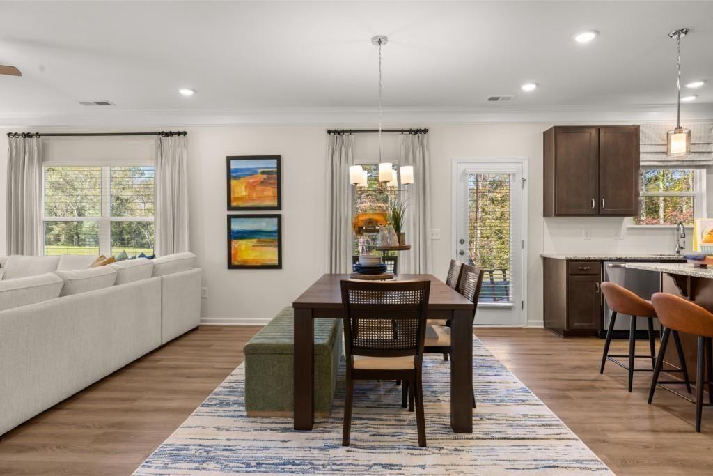523 Grover Street Hoschton, GA 30548 - Photo 11 of 50 a view of a dining room with furniture window and wooden floor