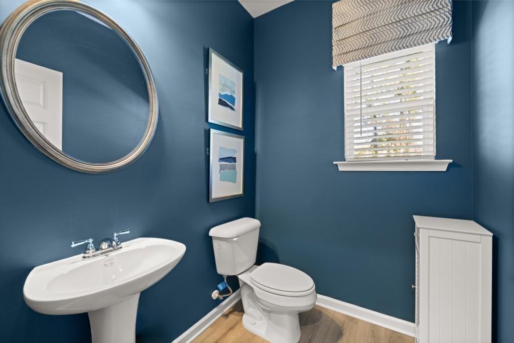 523 Grover Street Hoschton, GA 30548 - Photo 22 of 50 a bathroom with a toilet sink and mirror