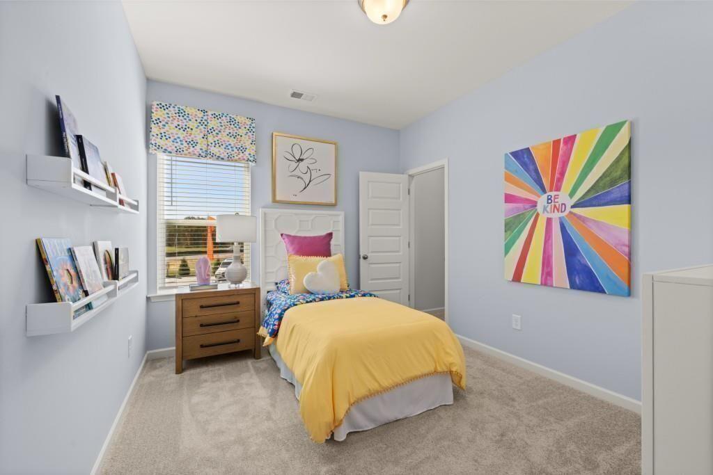 523 Grover Street Hoschton, GA 30548 - Photo 46 of 50 a bedroom with a bed and painting on the wall
