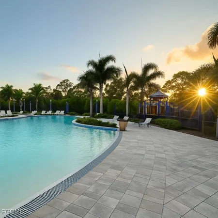 a view of a swimming pool and lounge chairs