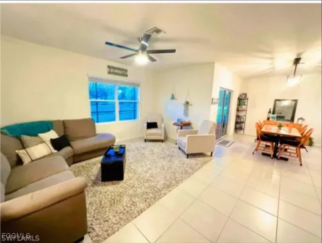 a living room with furniture and a lamp