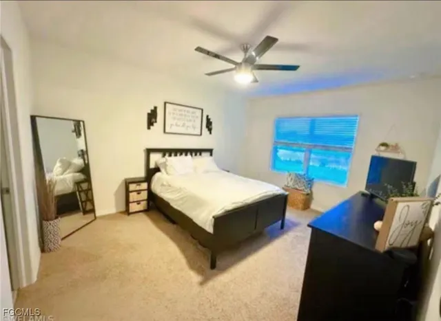 a bedroom with a bed and a mirror