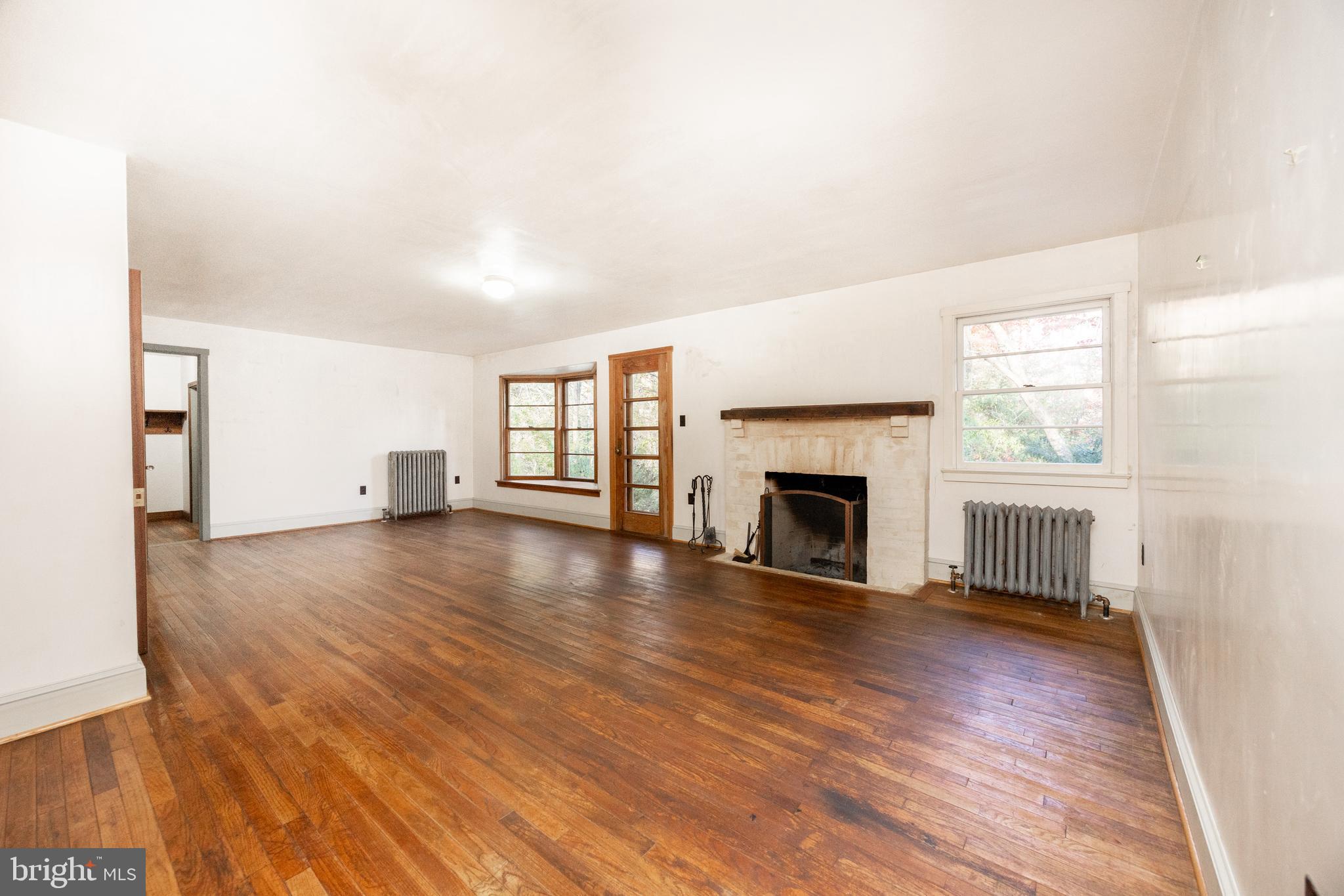 22 Bertolet School Road Spring City, PA 19475 - Photo 16 of 25 a view of a livingroom with wooden floor and a fireplace