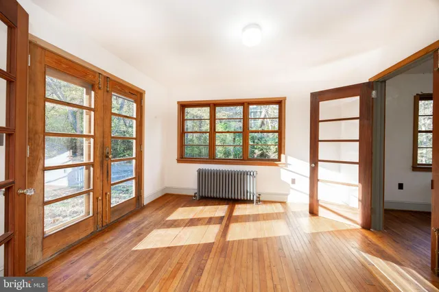wooden floor in an empty room with a window