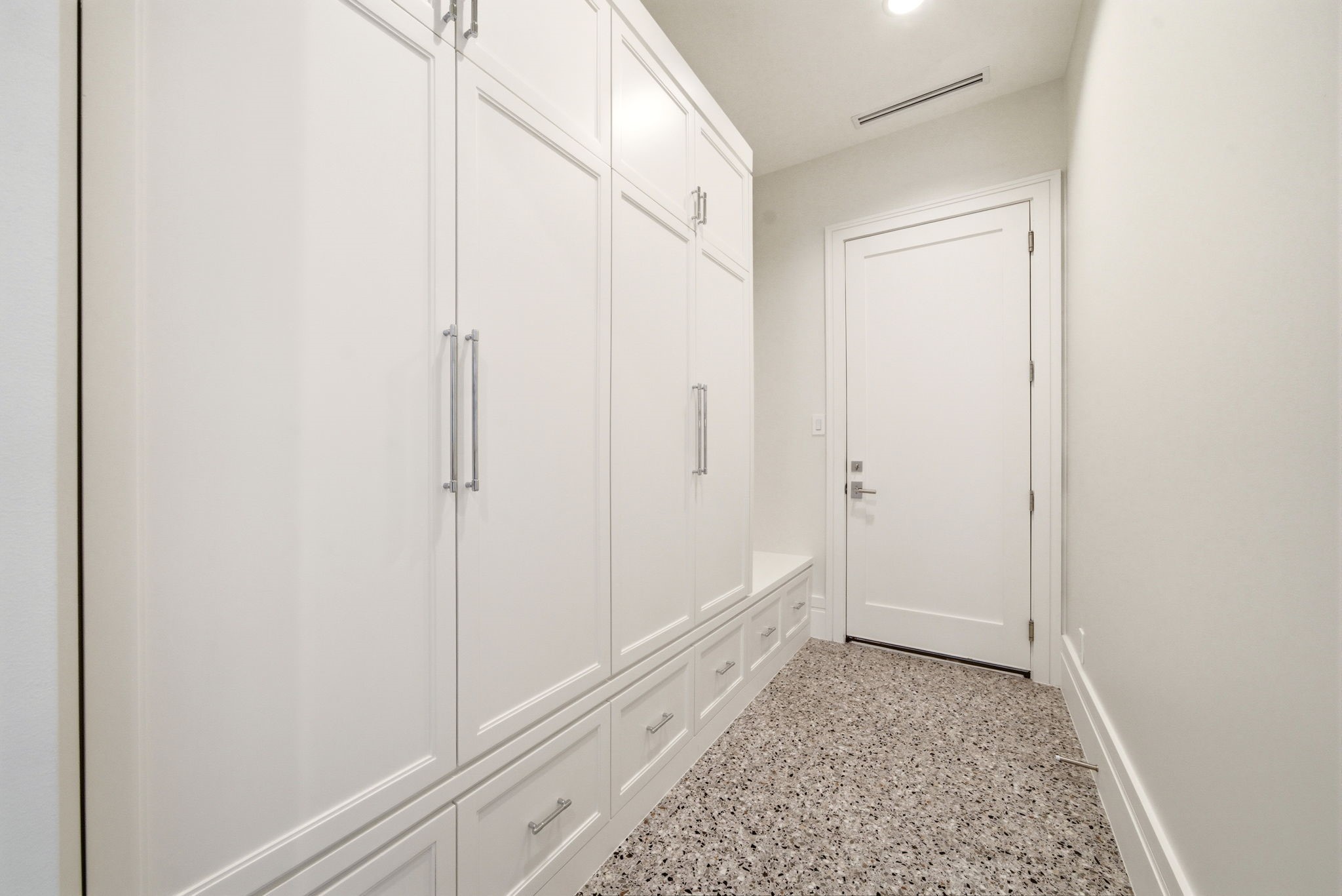 1023 Euclid Street Houston, TX 77009 - Photo 20 of 50 Mudroom-style storage corridor with floor-to-ceiling built-ins, abundant cabinetry, and durable terrazzo-inspired flooring.