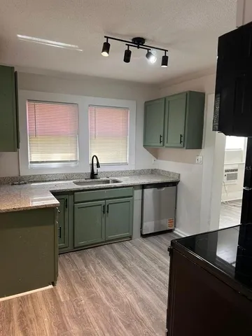 a kitchen with a sink and a refrigerator