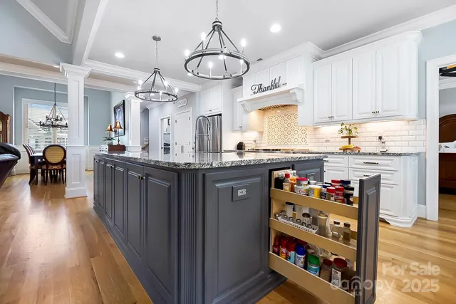 a kitchen with lots of counter top space and wooden floor