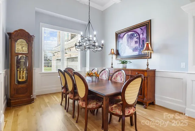 a dining room with furniture and chandelier