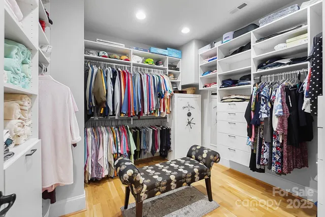 a view of walk in closet with clothes