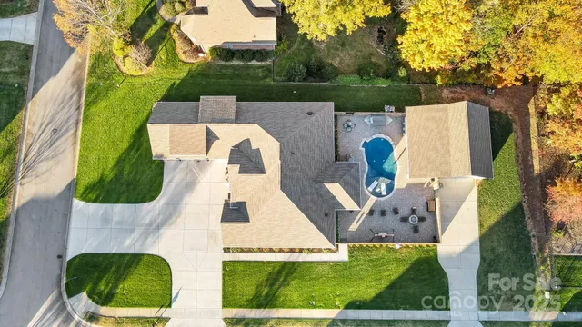 an aerial view of a house with a yard