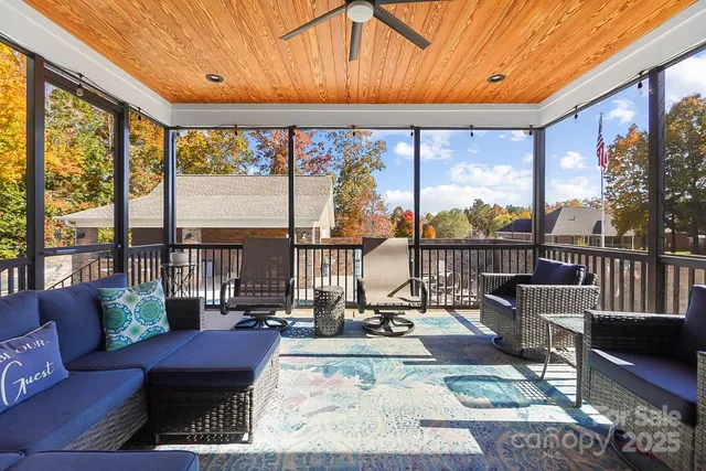 a living room with furniture tv and a large window