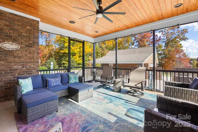 a living room with furniture and a floor to ceiling window