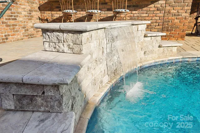 a view of swimming pool with outdoor seating