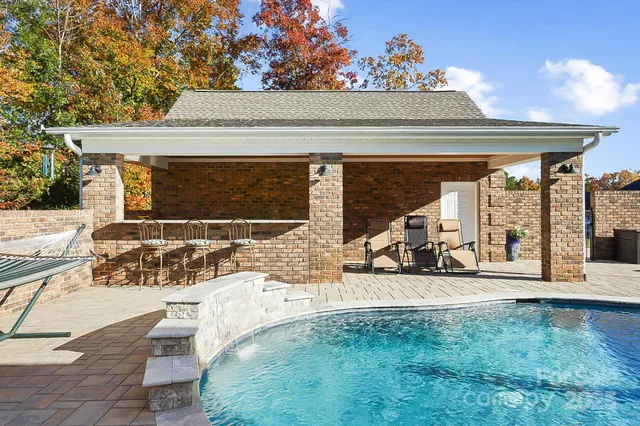 a view of a patio with table and chairs a barbeque and potted plants
