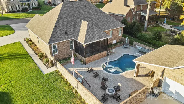 an aerial view of a house with swimming pool and big yard