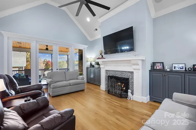 a living room with furniture a flat screen tv and a fireplace