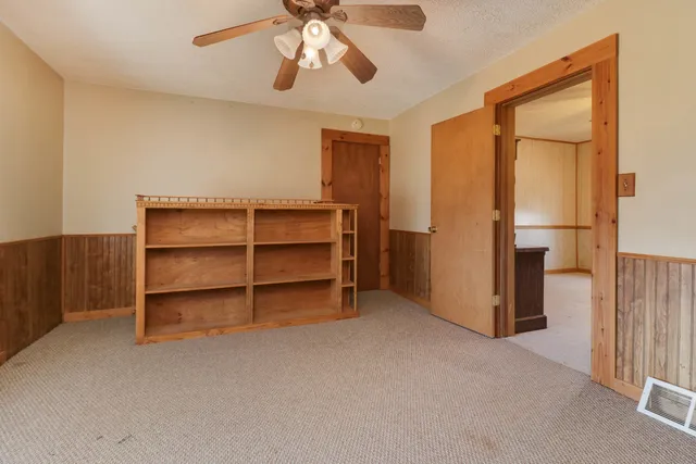 a view of an empty room with a cabinet and a cabinet