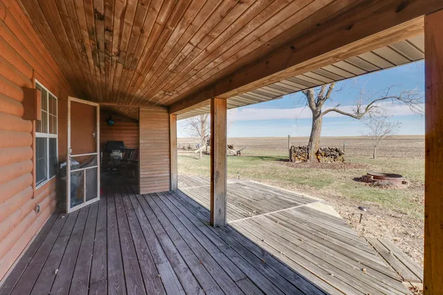 a view of a porch with wooden floor and outdoor space