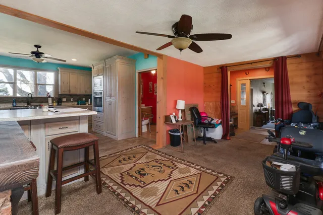 a living room with furniture and a chandelier
