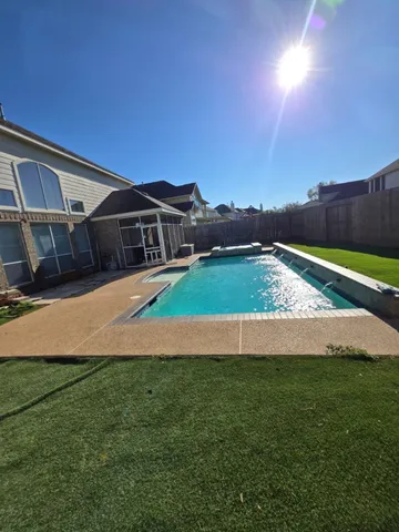 a view of an house with backyard and pool