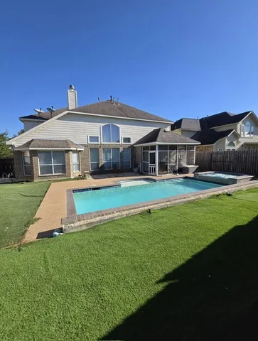 a front view of a house with a yard table and chairs