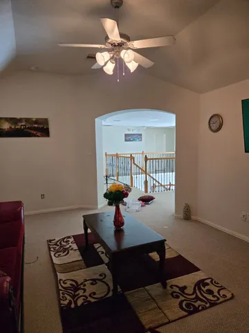 a living room with furniture and a chandelier