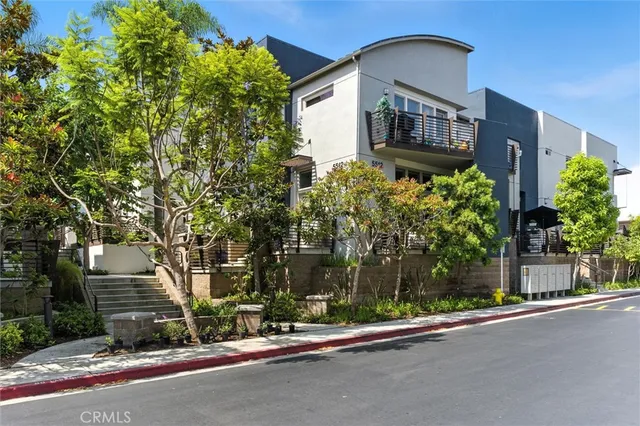 a couple of cars parked in front of a house