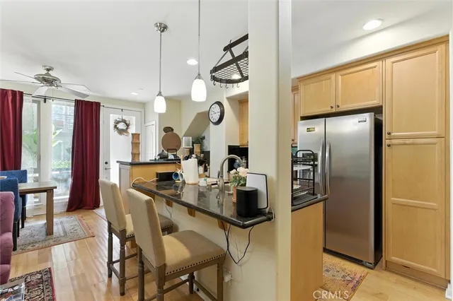a kitchen with a refrigerator a sink and cabinets