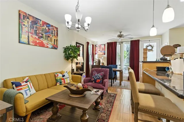 a living room with fireplace furniture and a chandelier