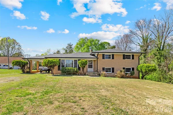a front view of a house with a yard patio and fire pit