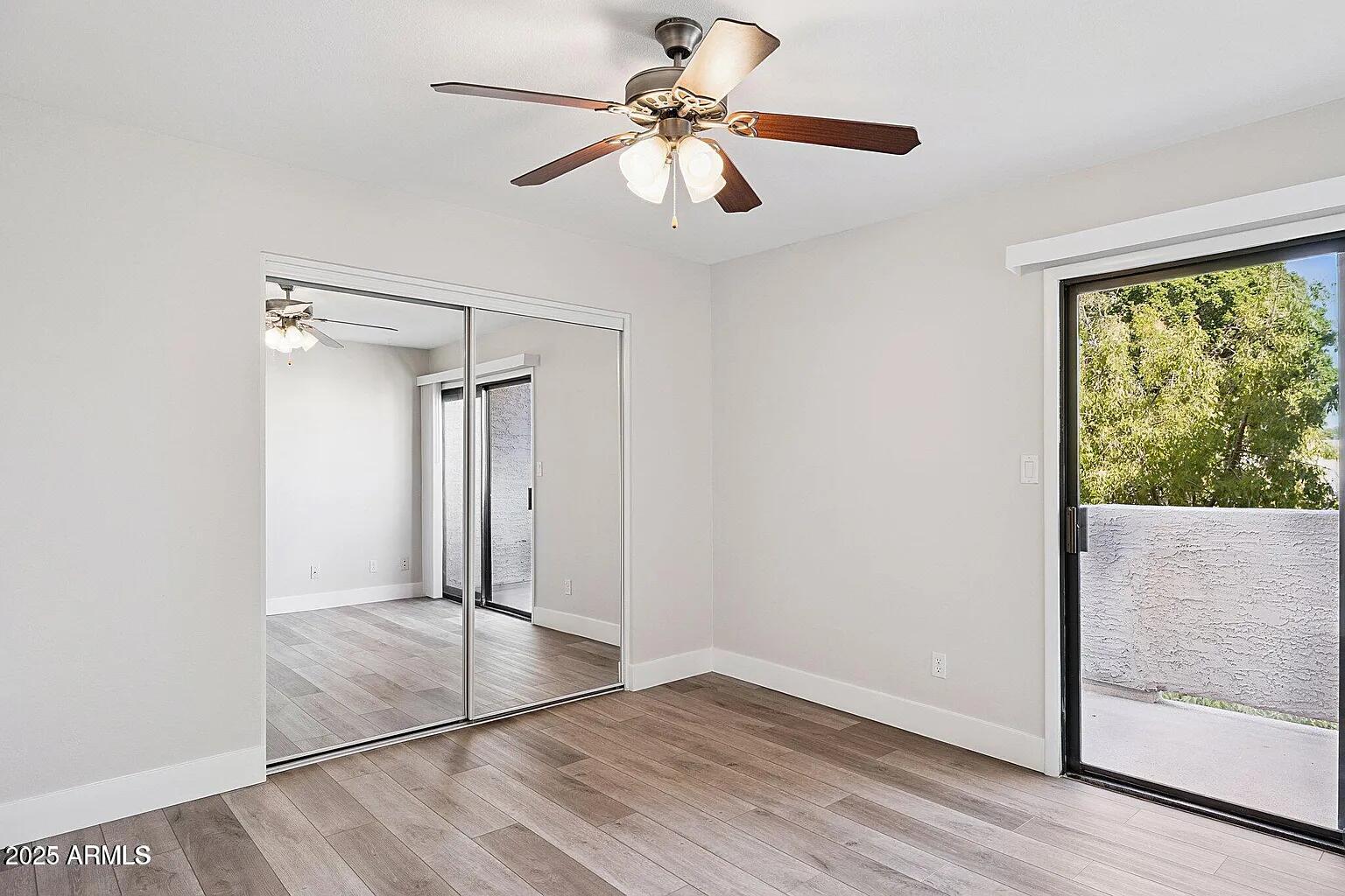 935 North Granite Reef Road, Unit 100 Scottsdale, AZ 85257 - Photo 14 of 29 an empty room with fan and windows