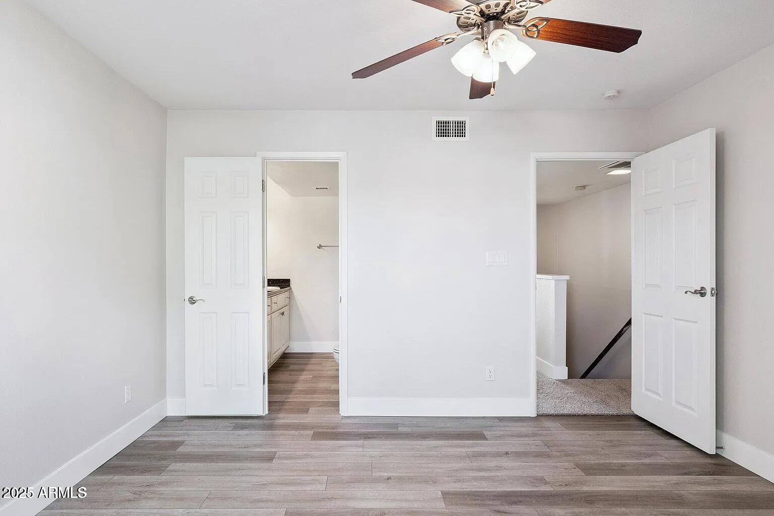 935 North Granite Reef Road, Unit 100 Scottsdale, AZ 85257 - Photo 15 of 29 an empty room with wooden floor and ceiling fan