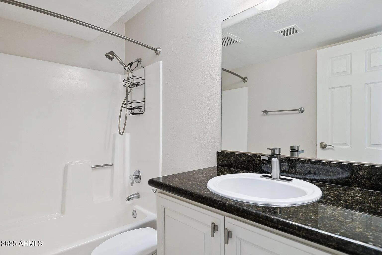 935 North Granite Reef Road, Unit 100 Scottsdale, AZ 85257 - Photo 21 of 29 a bathroom with a granite countertop sink toilet and shower
