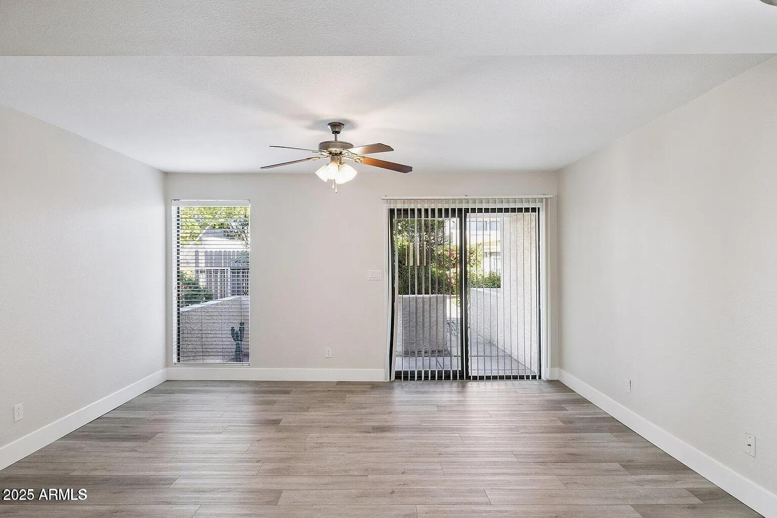 935 North Granite Reef Road, Unit 100 Scottsdale, AZ 85257 - Photo 4 of 29 wooden floor in an empty room with a window