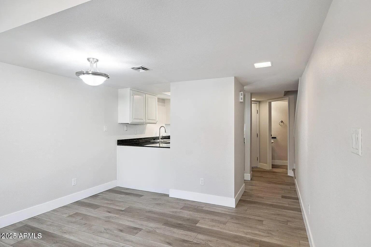 935 North Granite Reef Road, Unit 100 Scottsdale, AZ 85257 - Photo 7 of 29 a view of a kitchen with a sink and a refrigerator