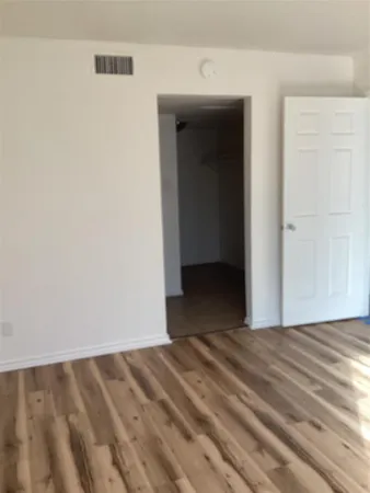a view of a room with wooden floor