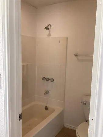 a bathroom with a bathtub and a toilet